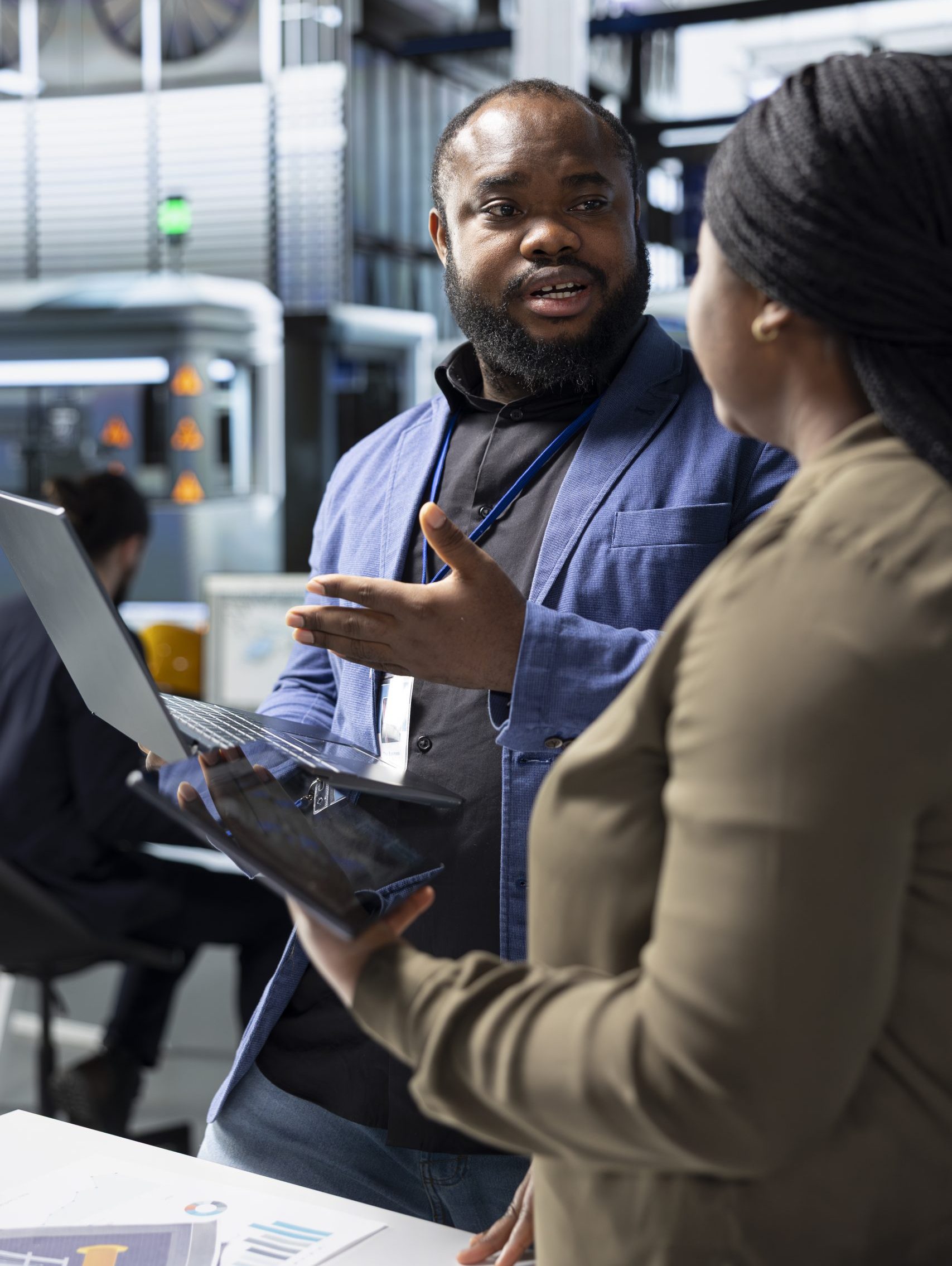 African american team of energy consultants analyzing insight in solar plant African american team of energy consultants analyzing insight in solar panel plant, ensuring high standards in renewable energy production line, quality control and manufacturing efficiency.